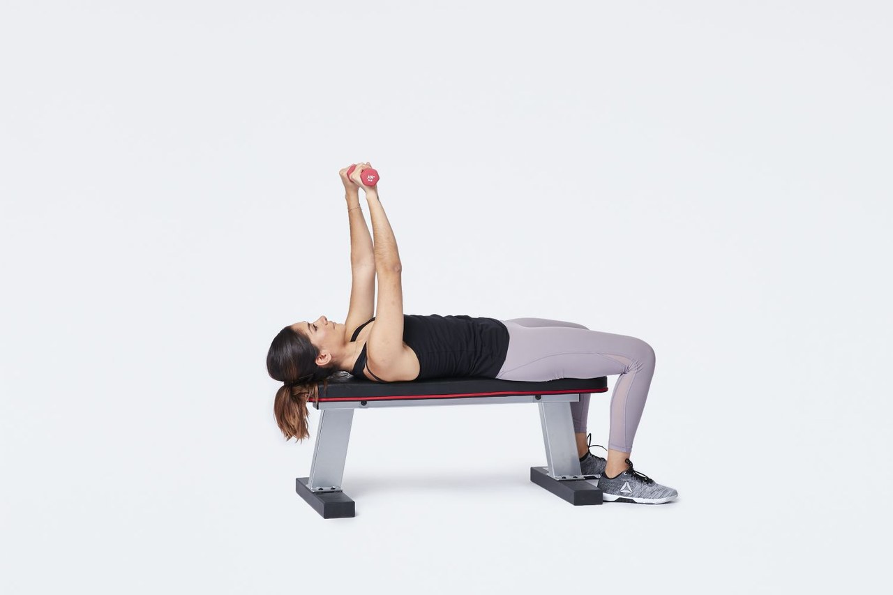 Chest Press demonstrated (Verywell Fit lead image)